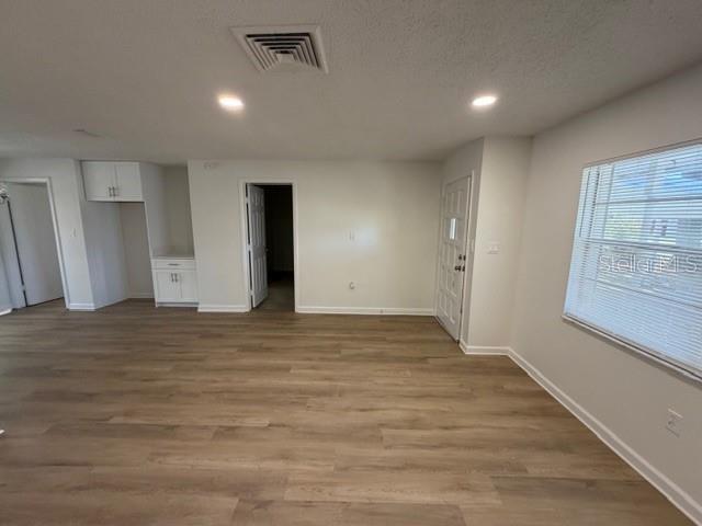 A bedroom with beige carpet, white walls, a closet with louvered doors, and two doorways — 3736 PINE CIRCLE, LAKE WALES, FL