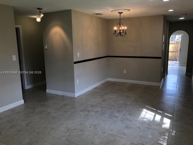 An interior view shows a dining area with tile flooring and a decorative chandelier — 6230 SW 129 PL # 1210, Miami FL 33183, MIAMI, FL
