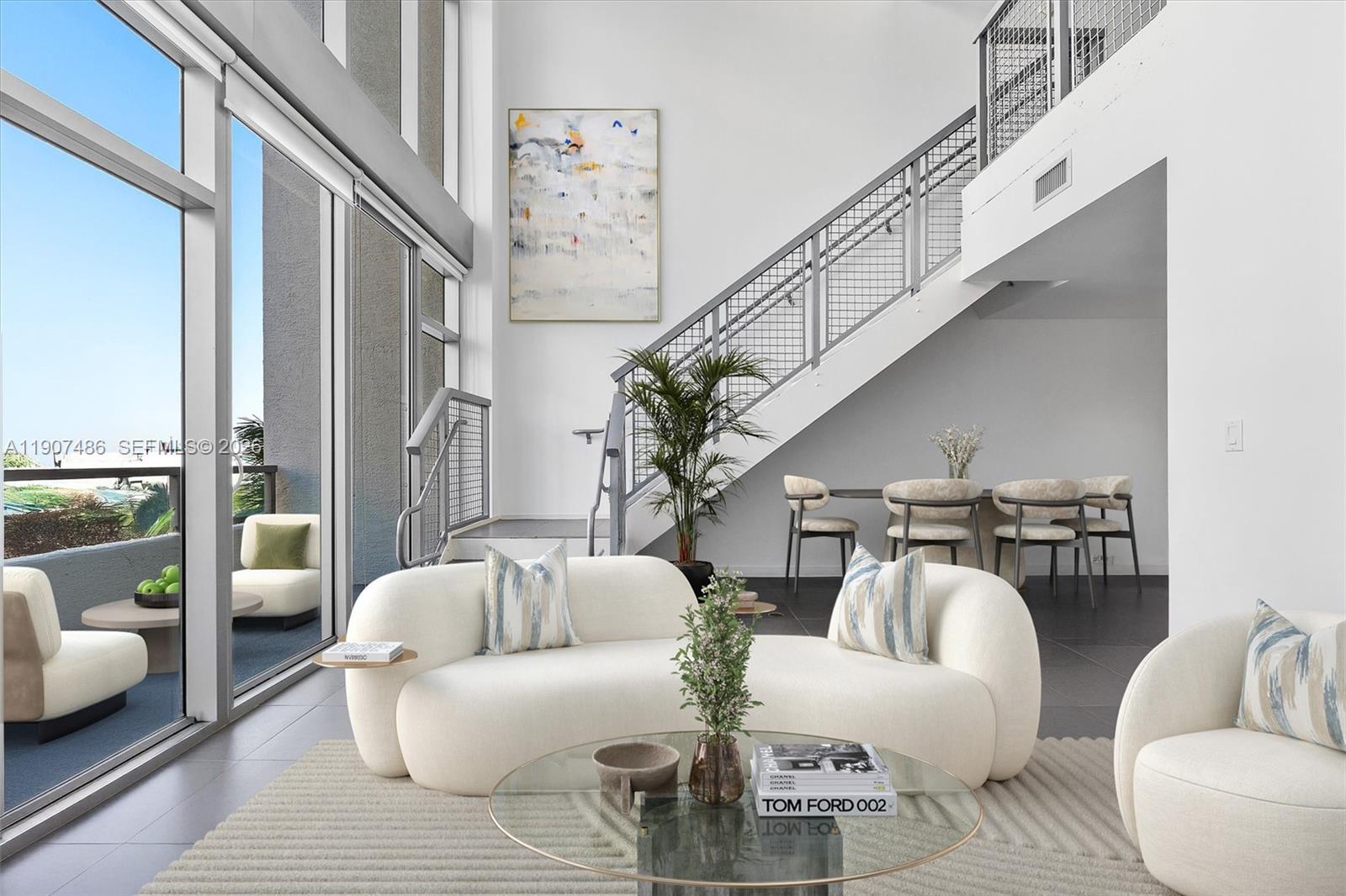 A modern living room features high ceilings, floor-to-ceiling windows, a wet bar, and white furniture — 3301 NE 1st Ave # M0502, Miami FL 33137, MIAMI, FL