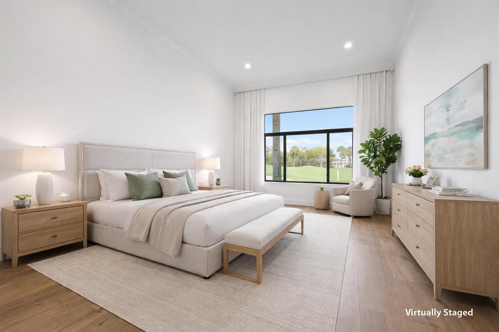 A bright bedroom features a king bed, wooden furniture, and a large window overlooking greenery — 108 Waters Edge Drive, Jupiter FL 33477, JUPITER, FL