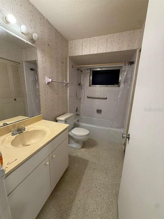 A bathroom features a vanity with a sink, a toilet, and a shower-tub combination — 21385 GIBRALTER DRIVE, PORT CHARLOTTE, FL