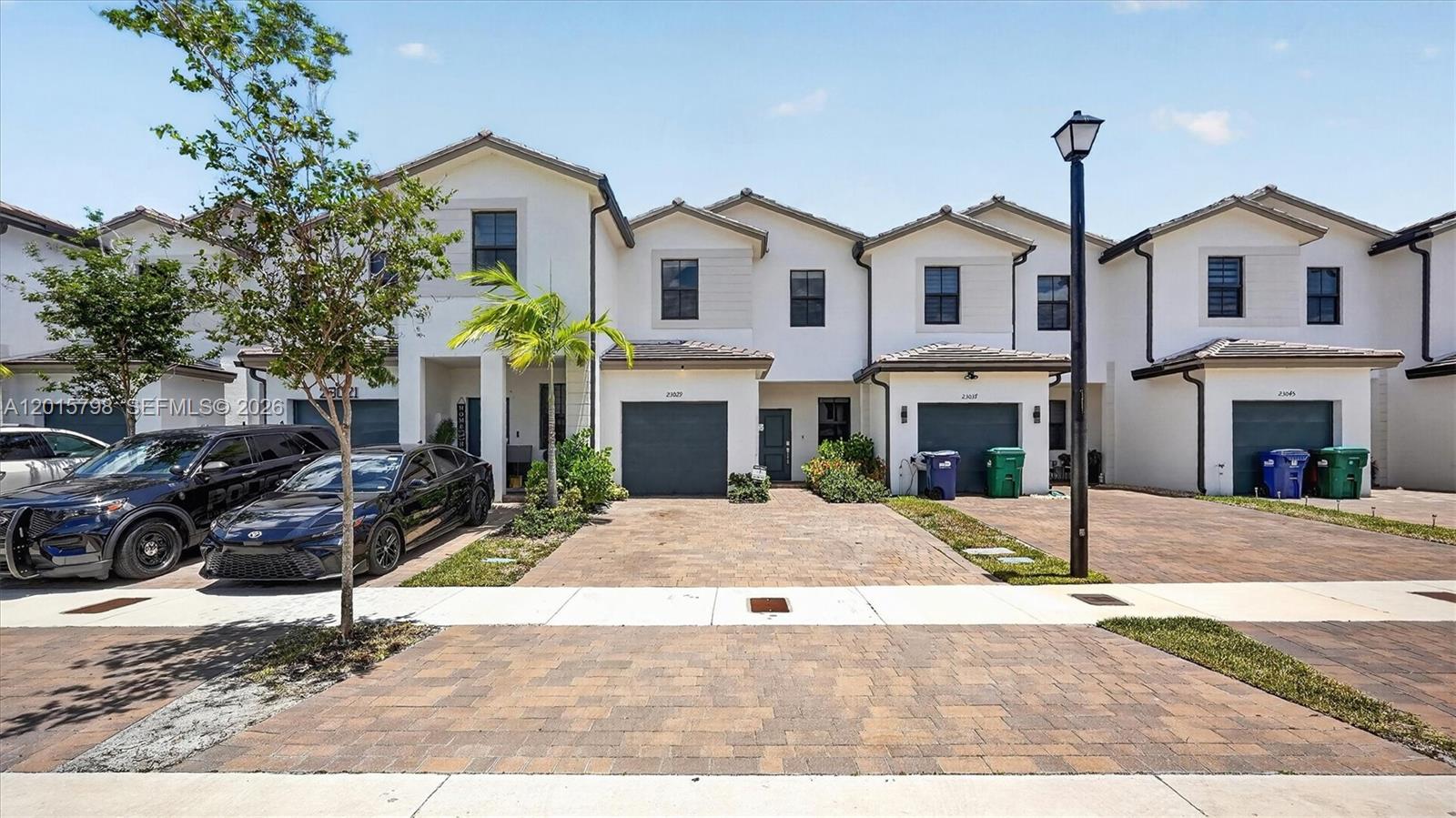 A row of modern two-story townhomes with paved driveways and attached garages — 23029 SW 128th Pl, Miami FL 33170, MIAMI, FL