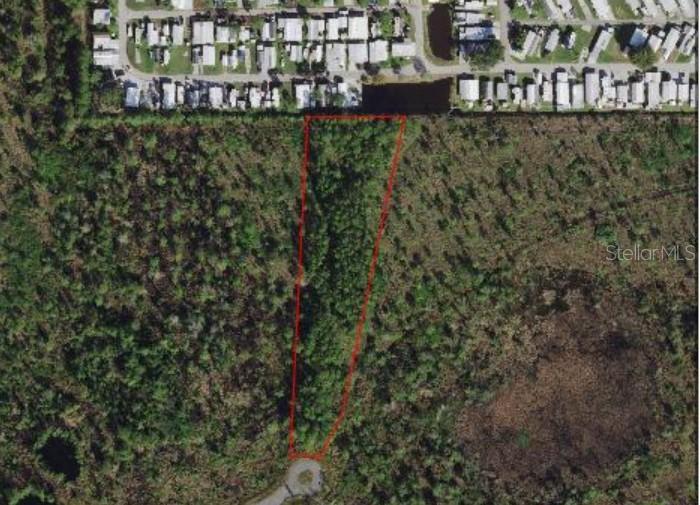 An aerial view shows a wedge-shaped vacant lot outlined in red near a residential area — EGRET DRIVE, FROSTPROOF, FL