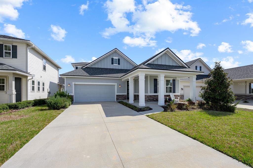 A single-story house with a gray garage, covered front porch, and light blue siding — 41 LOS LAGOS BOULEVARD, PALM COAST, FL