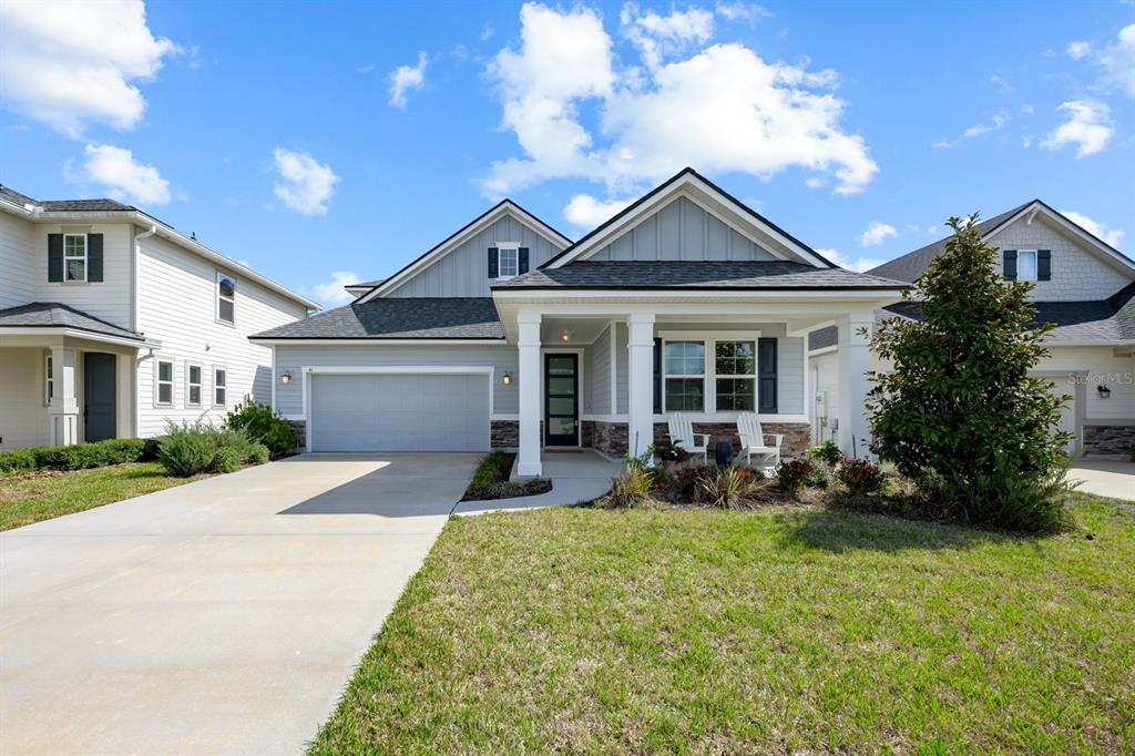 A light gray single-story house with a two-car garage and a covered front porch — 41 LOS LAGOS BOULEVARD, PALM COAST, FL