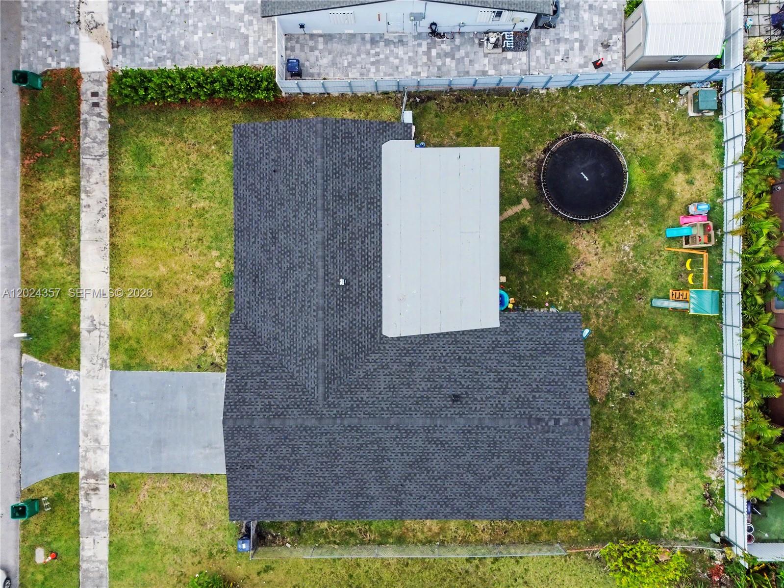 An aerial view shows a house with a dark shingled roof and a backyard — 16912 SW 107th Pl, Miami FL 33157, MIAMI, FL
