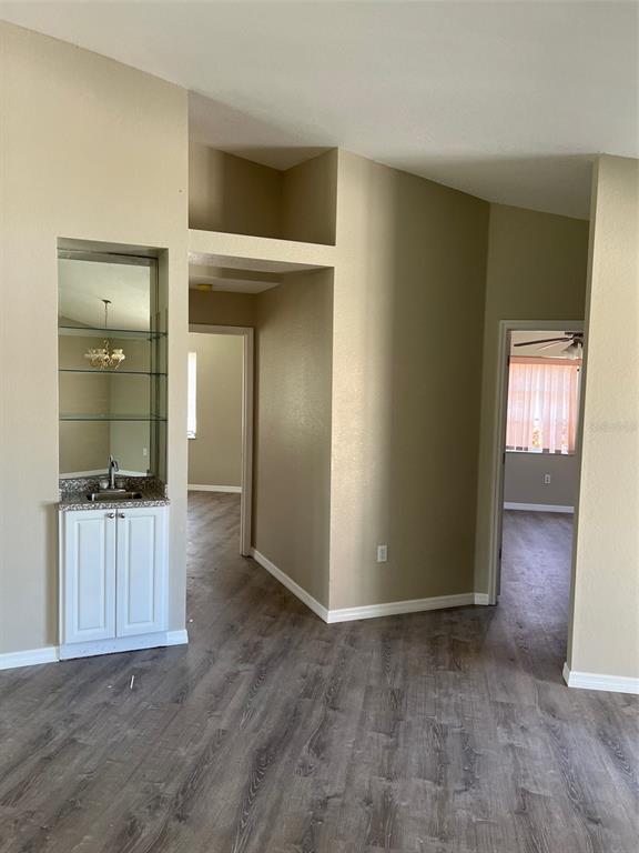A wet bar with glass shelves sits next to two doorways leading into other rooms — 1330 ABALOM STREET, PORT CHARLOTTE, FL
