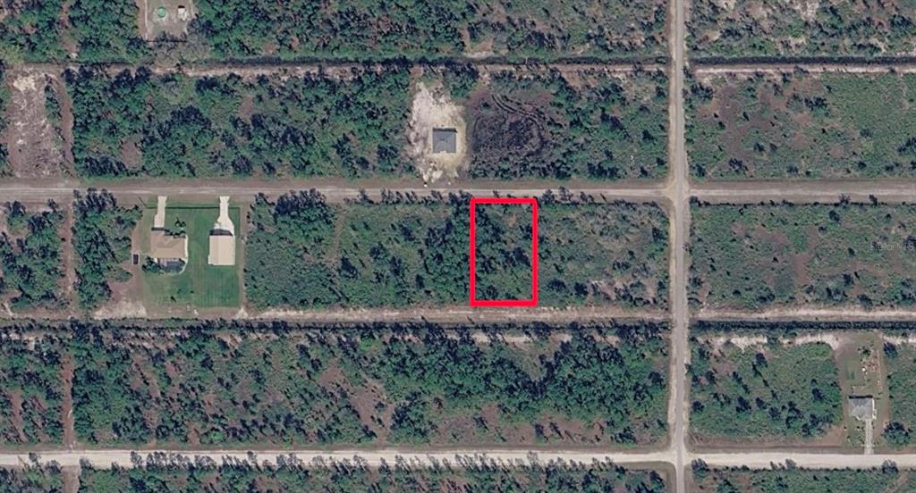 An aerial view shows a rectangular vacant lot outlined in red within a wooded area — GAILLARDIA DRIVE, INDIAN LAKE ESTATES, FL
