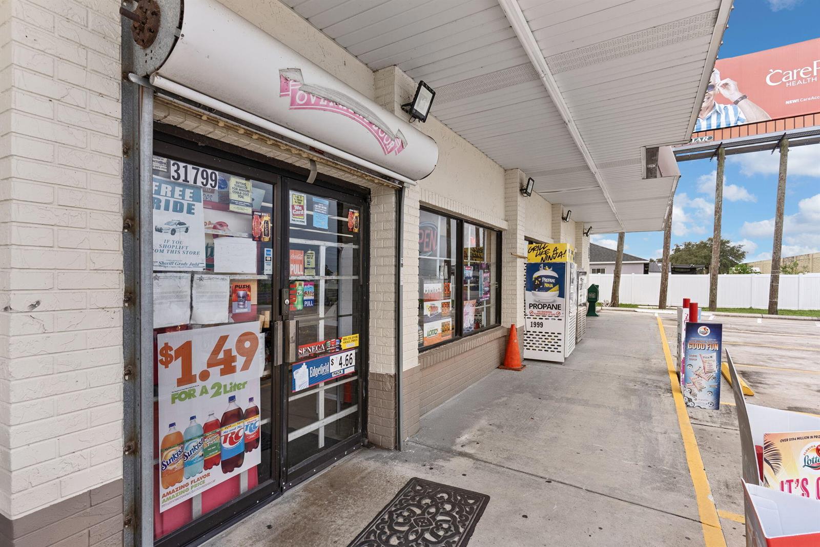 The exterior of a convenience store features a glass entrance door and a propane exchange — 31799 Us Hwy 27, FL 33844, FL
