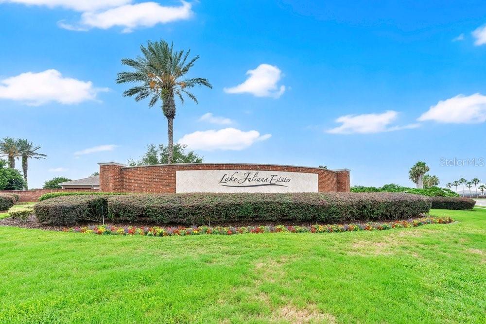 A brick entrance sign for Lake Juliana Estates stands in a landscaped grassy area — 4265 JULIANA LAKE DRIVE, AUBURNDALE, FL