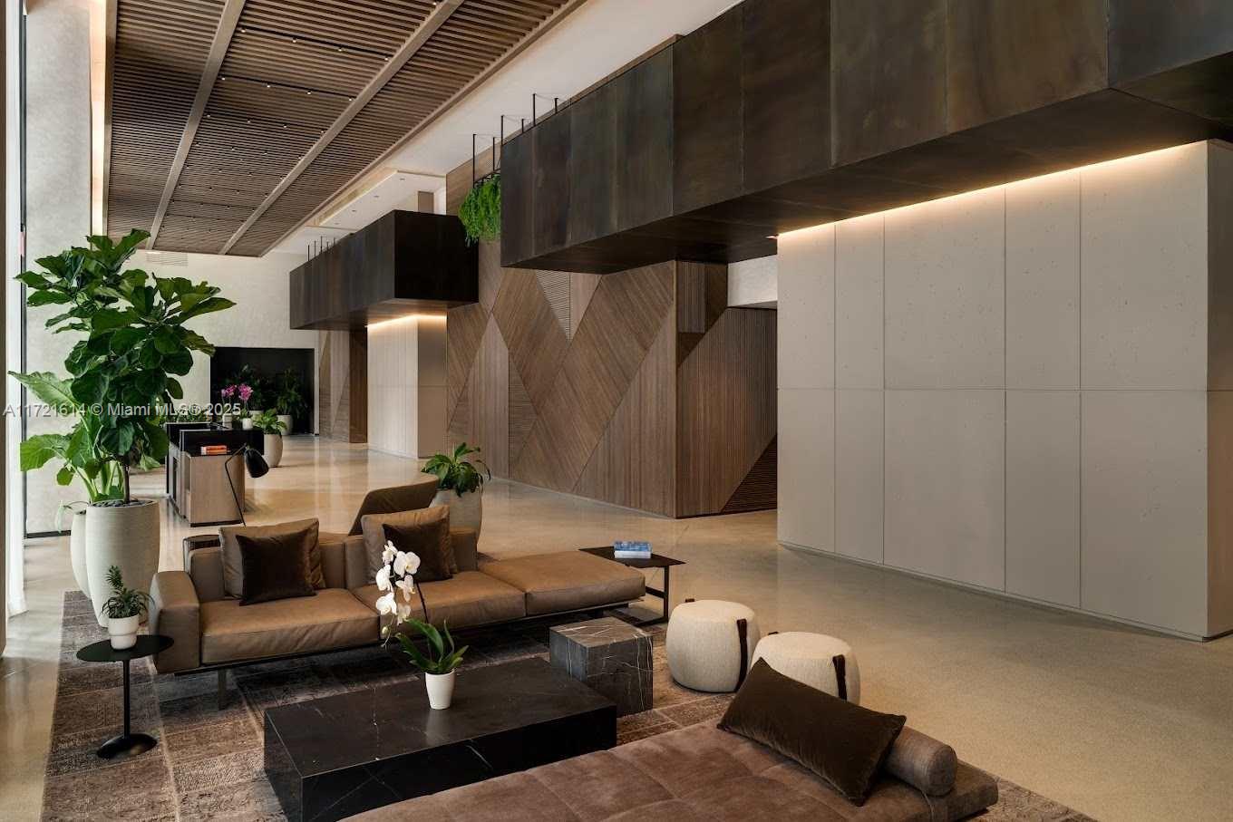 A modern lobby features wood-paneled walls, a brown sofa, and a slatted ceiling — 159 NE 6 # 3912, Miami FL 33132, MIAMI, FL