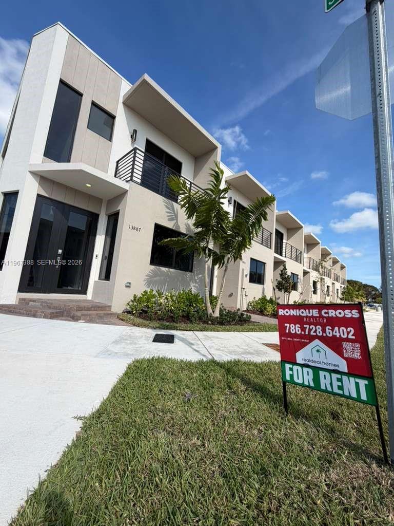 A modern multi-story townhouse exterior with a for rent sign in the front yard — 13888 SW 261st Ter # 0, Miami FL 33032, MIAMI, FL