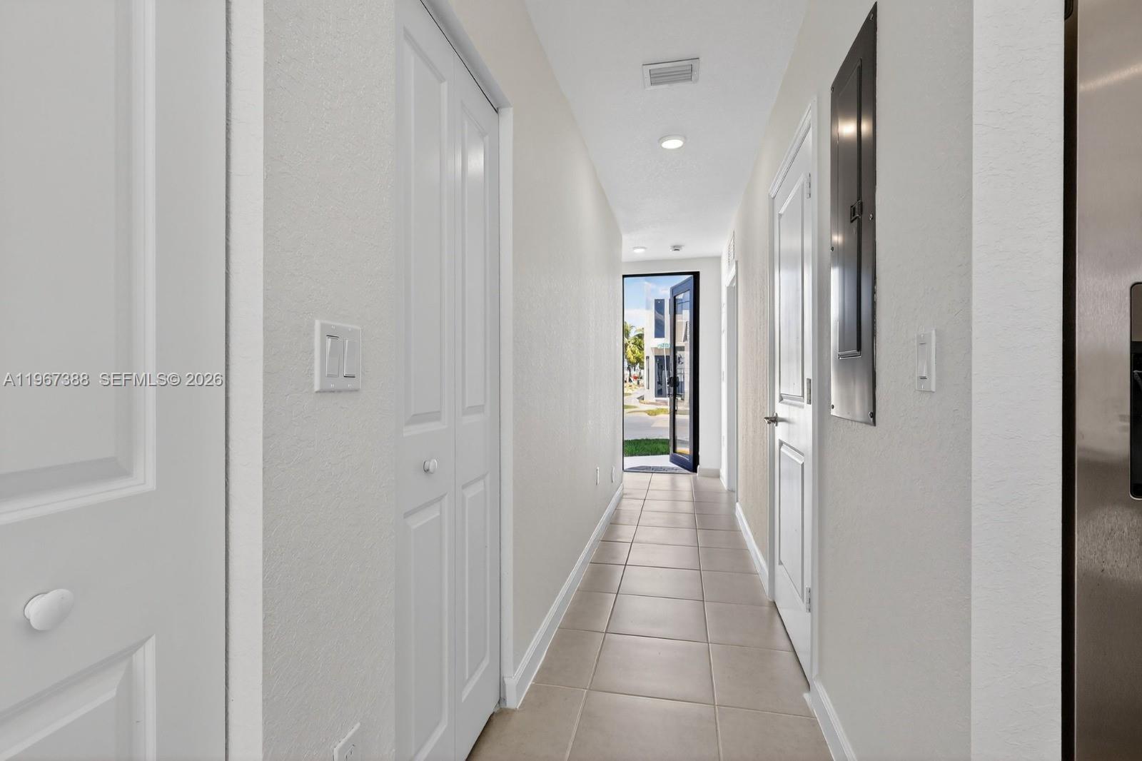 A tiled hallway leads to an open exterior door with white doors on both sides — 13888 SW 261st Ter # 0, Miami FL 33032, MIAMI, FL