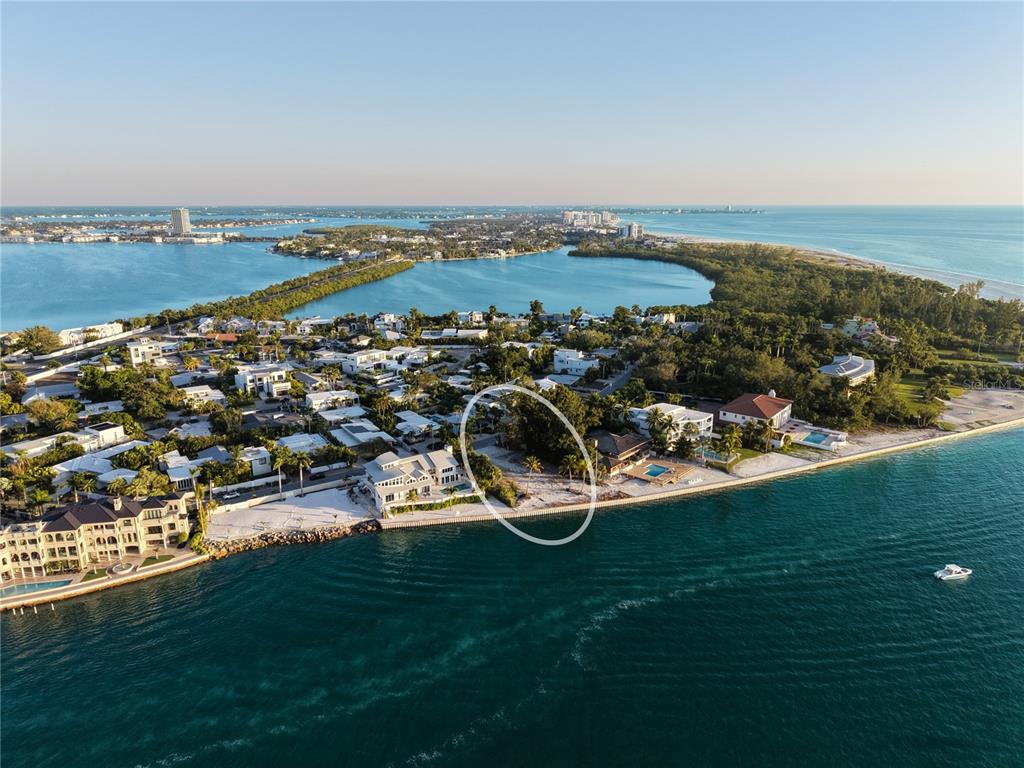 An aerial view of a coastal neighborhood featuring a vacant waterfront lot circled in white — 1199 WESTWAY DRIVE, SARASOTA, FL