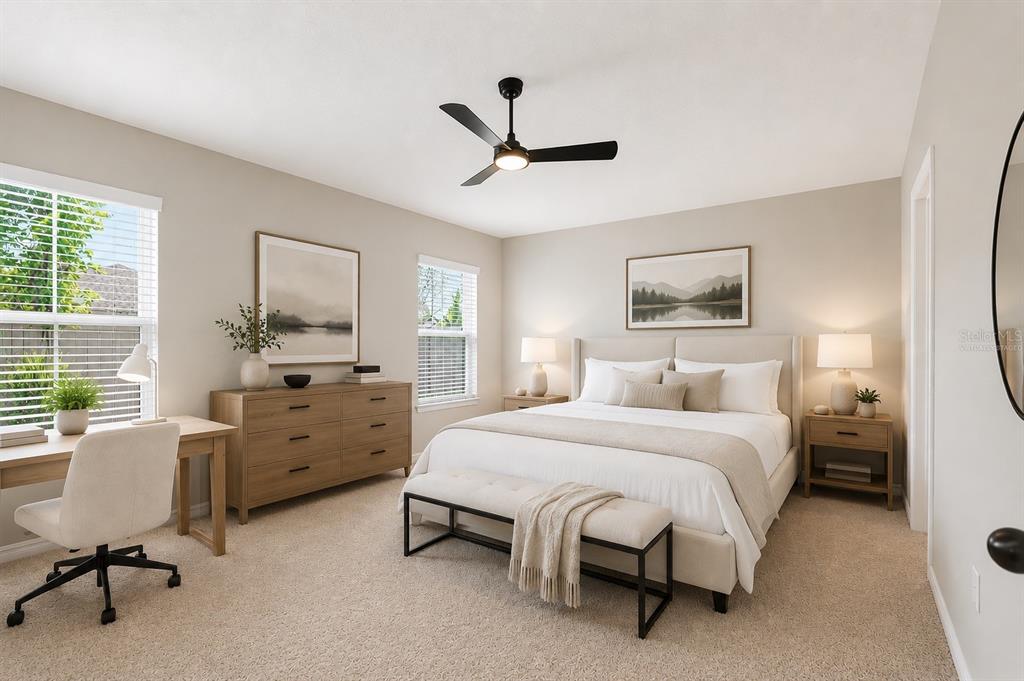 A bedroom features a bed, a desk, a dresser, and a ceiling fan — 14919 STERLING SPUR AVENUE, LITHIA, FL