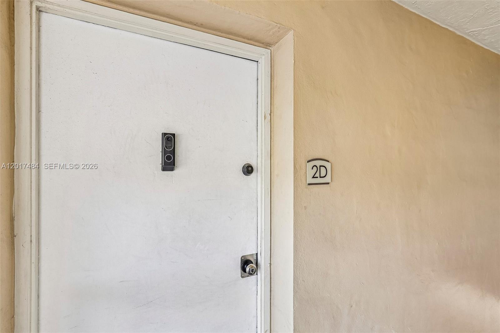 A white apartment door with a smart doorbell and the number 2D on the wall — 4520 NW 79th Ave # 2D, Doral FL 33166, DORAL, FL