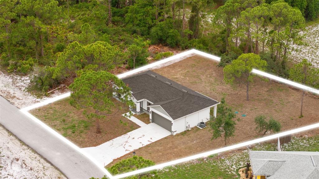 An aerial view shows a single-story house with a gray roof and driveway on a lot — 108 OXBOW DRIVE, SEBRING, FL