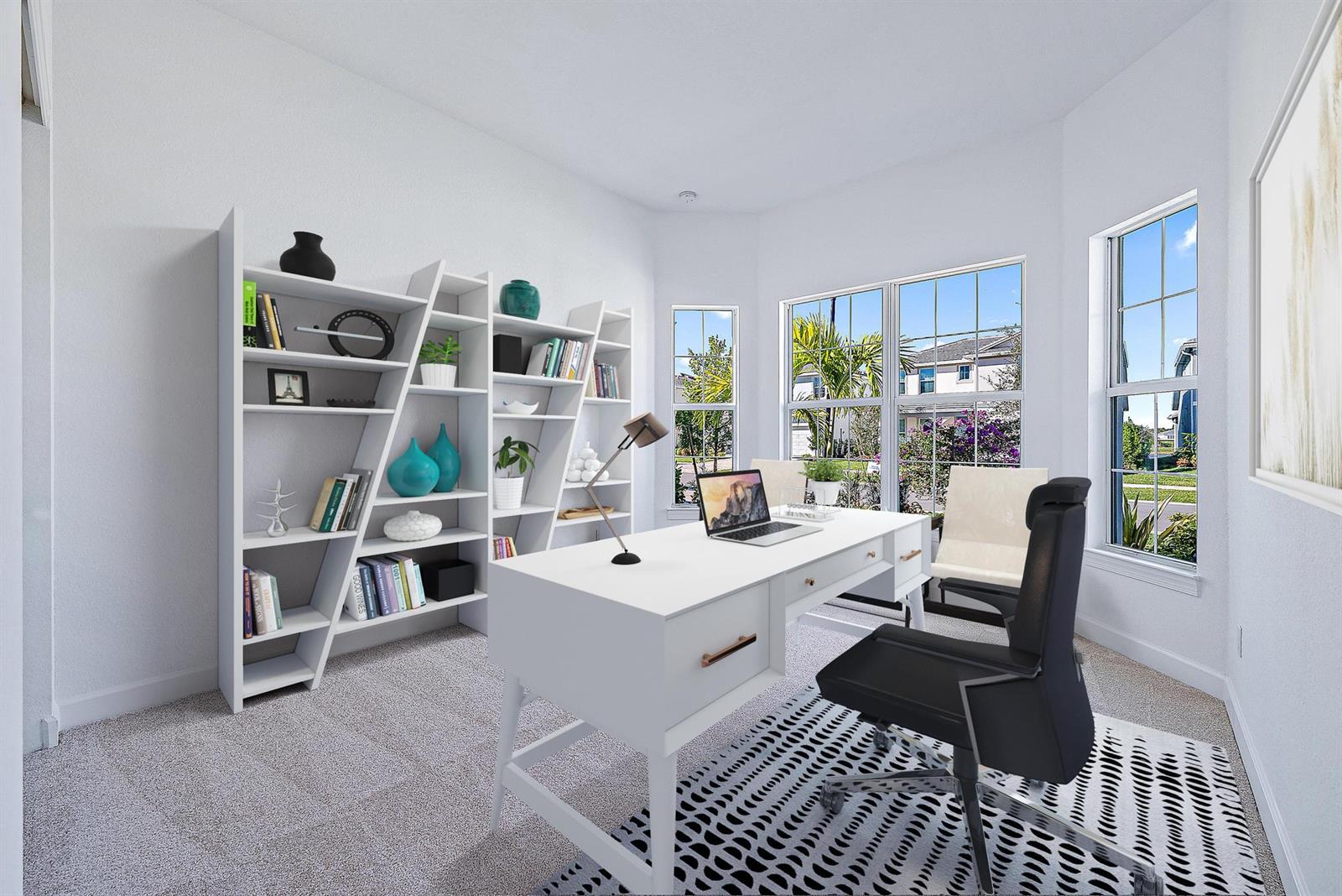 A home office features a white desk, a modern bookshelf, and windows overlooking a neighborhood — 9775 SW Meridian Way, Stuart FL 34997, STUART, FL