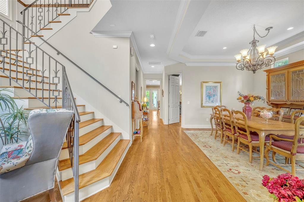 A dining room with a chandelier and staircase is visible in this interior home view — 1031 GUERNSEY STREET, ORLANDO, FL
