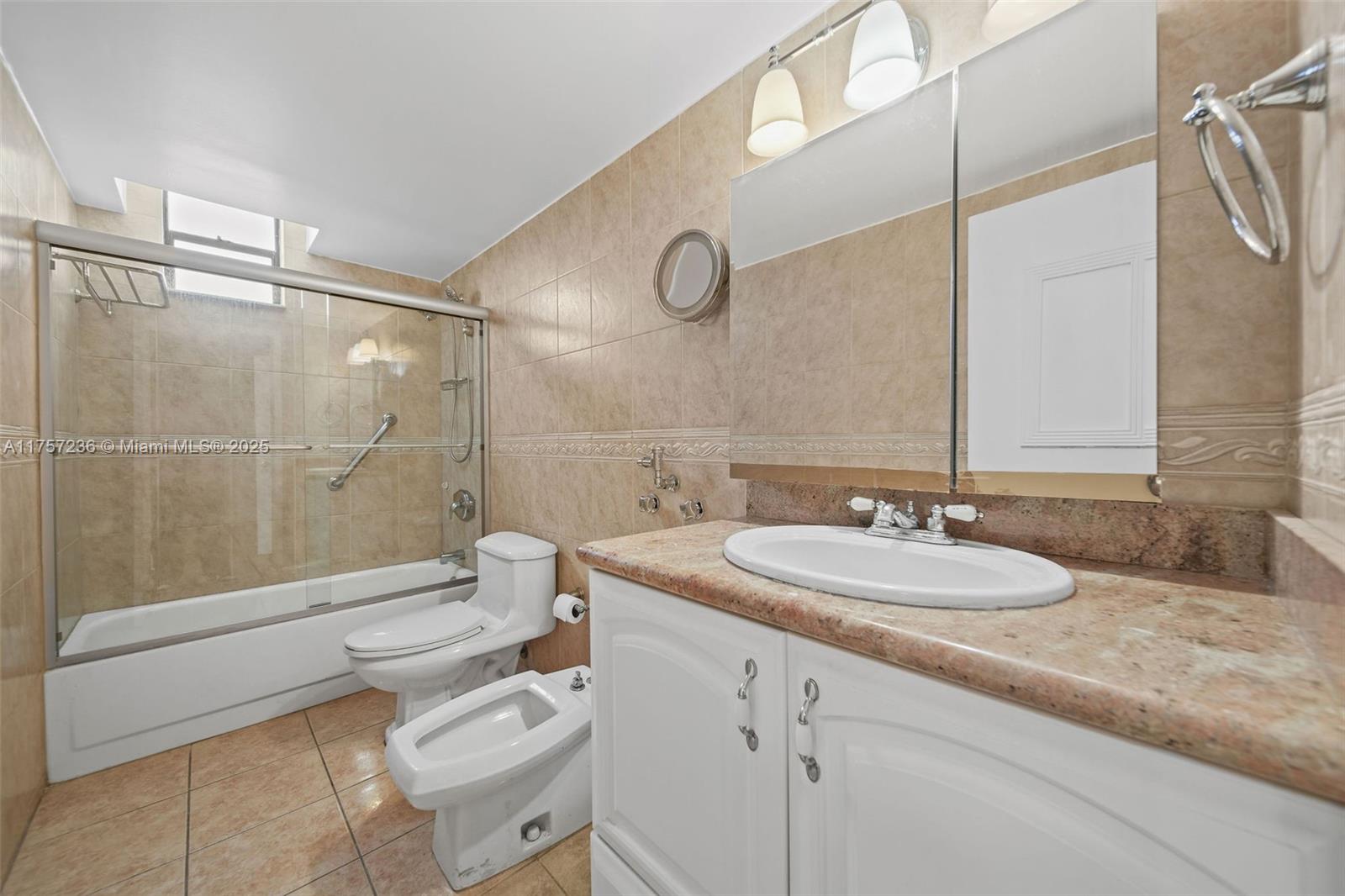A bathroom features a vanity with a stone countertop, a toilet, a bidet, and a shower — 2500 Parkview Dr # 812, Hallandale Beach FL 33009, HALLANDALE BEACH, FL