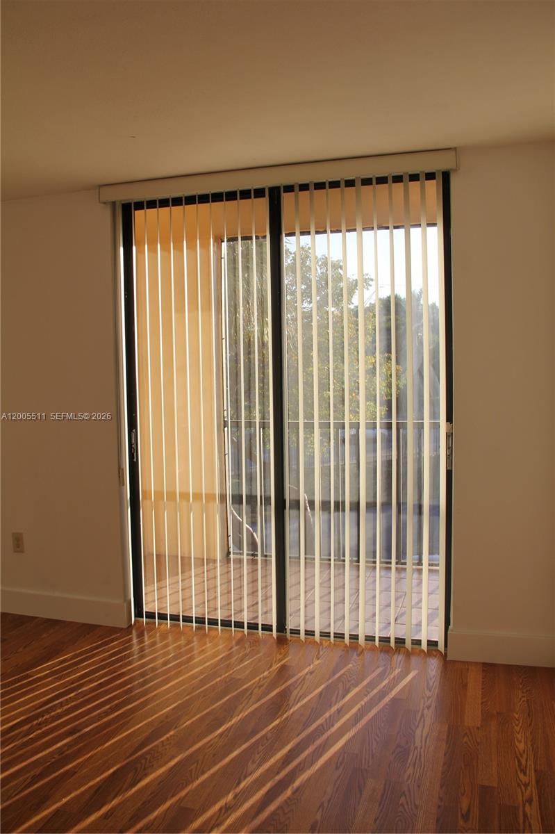 This closet features white shelving units and a metal hanging rod for clothing storage — 8700 SW 133rd Ave Rd # 301, Miami FL 33183, MIAMI, FL