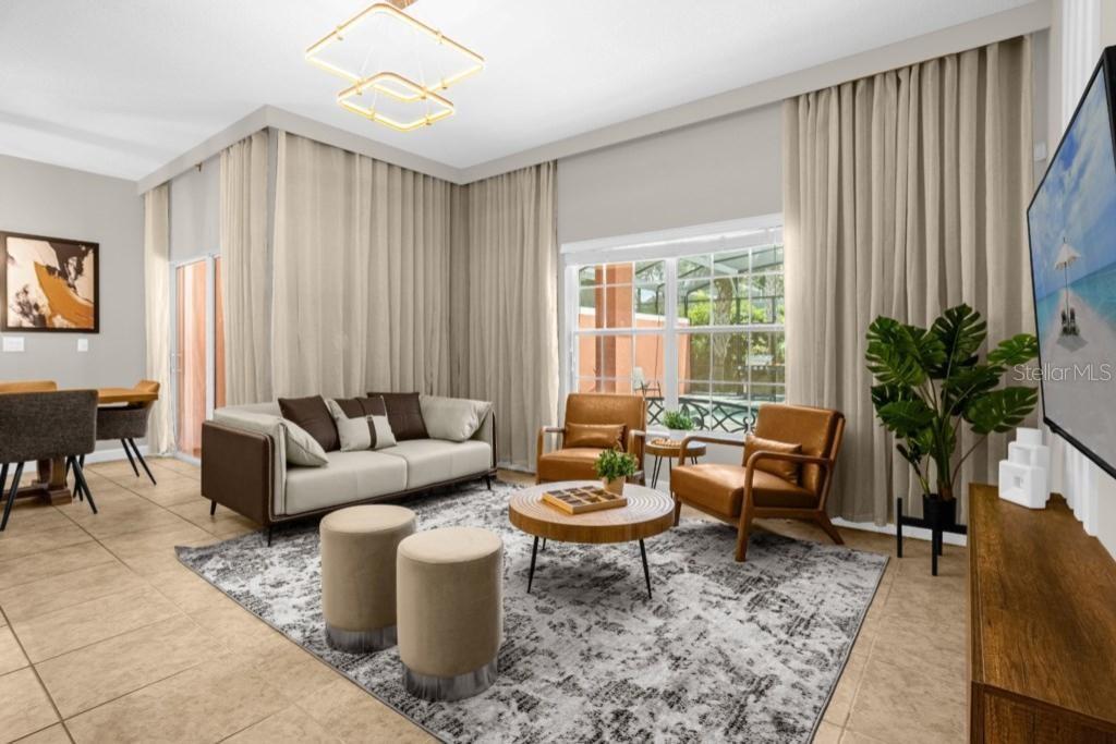 A living room features a sofa, two leather armchairs, a round coffee table, and floor-to-ceiling curtains — 2955 BANANA PALM DRIVE, KISSIMMEE, FL