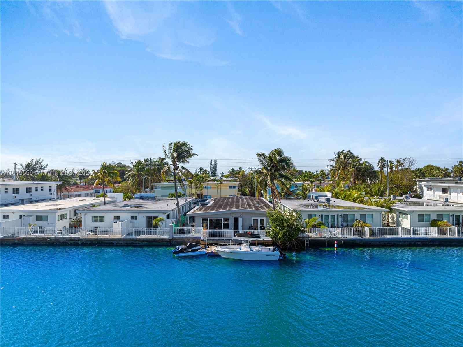 An aerial view shows a waterfront house with a boat docked at the seawall — 8221 Crespi Blvd, Miami Beach FL 33141, MIAMI BEACH, FL