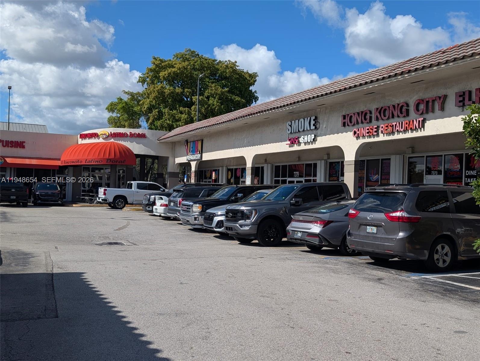 A strip mall exterior features several storefronts with a parking lot in front — 7373 NW 36th St, Miami FL 33166, MIAMI, FL