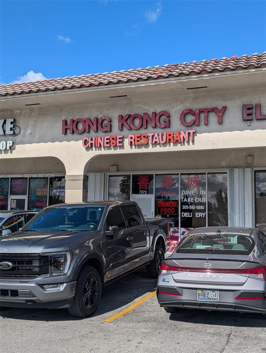 A gray Ford truck and a gray Hyundai sedan are parked in front of a restaurant — 7373 NW 36th St, Miami FL 33166, MIAMI, FL