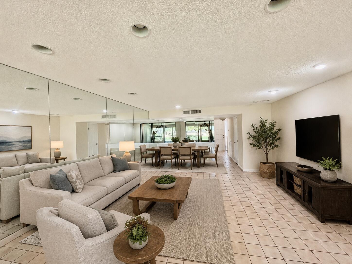 A spacious room with beige tile flooring, recessed lighting, and a large mirrored wall — 4807 Esedra Court, Lake Worth FL 33467, LAKE WORTH, FL