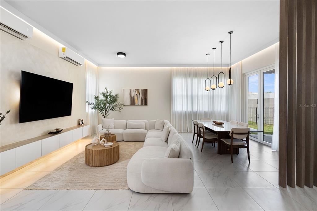 A modern open-concept living and dining area features white walls, tile floors, and neutral furniture — 153 RIVER TERRACE, JUNCOS, PR