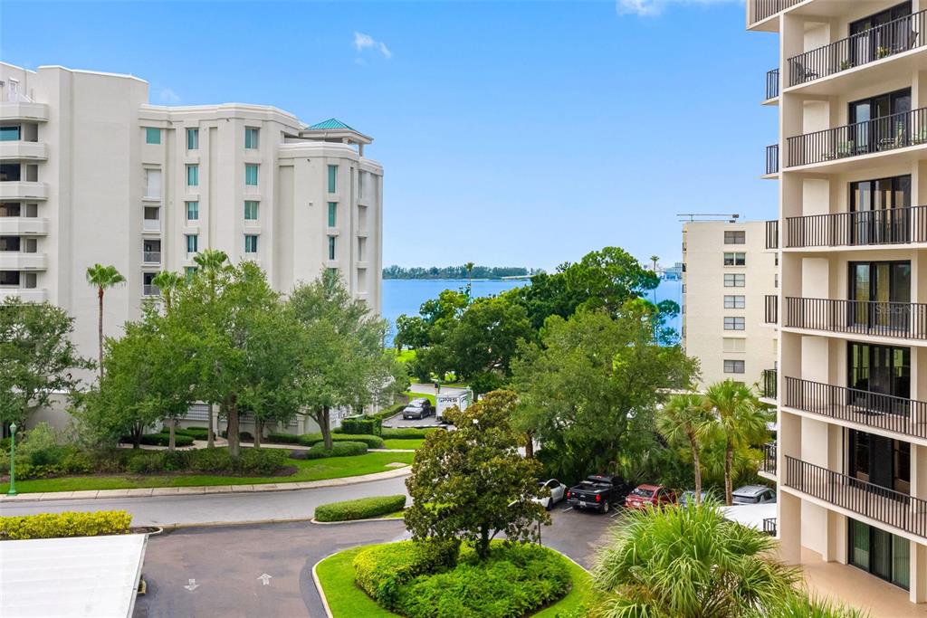 An elevated view shows two apartment buildings separated by a parking lot and green space — 150 BELLEVIEW BOULEVARD UNIT 401, BELLEAIR, FL