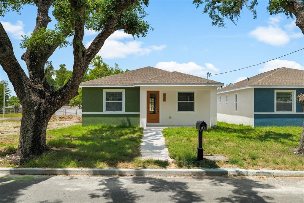 A single-story house with green and white exterior walls and a brown front door — 643 W 9TH STREET, LAKELAND, FL