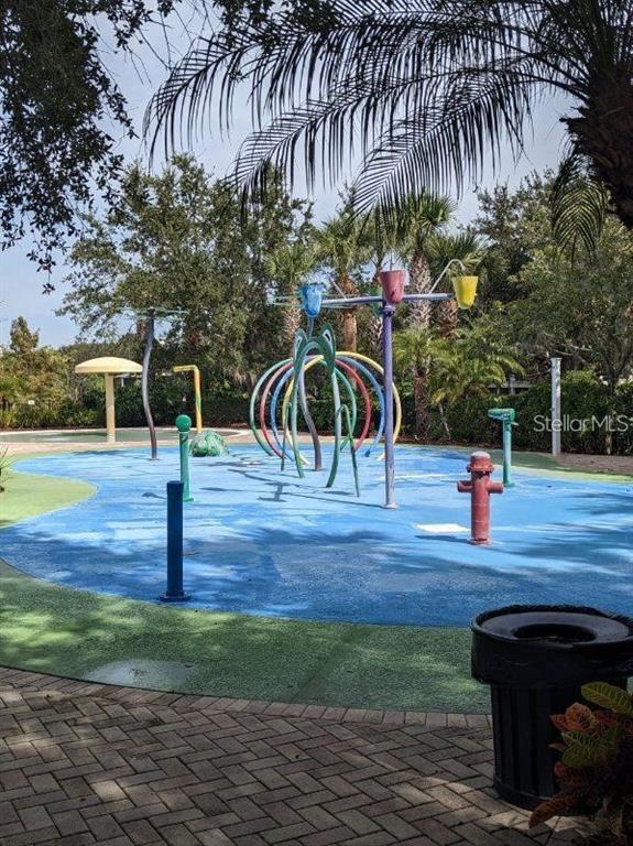 A colorful outdoor splash pad features water spray structures and a blue rubberized surface — 510 RUM RUN UNIT 510, DAVENPORT, FL