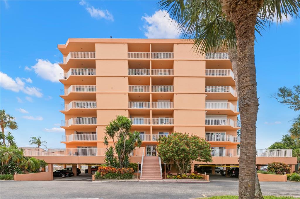A living room with a sofa, two armchairs, a coffee table, and sliding doors to a balcony — 7432 SUNSHINE SKYWAY LANE S UNIT 302, ST PETERSBURG, FL