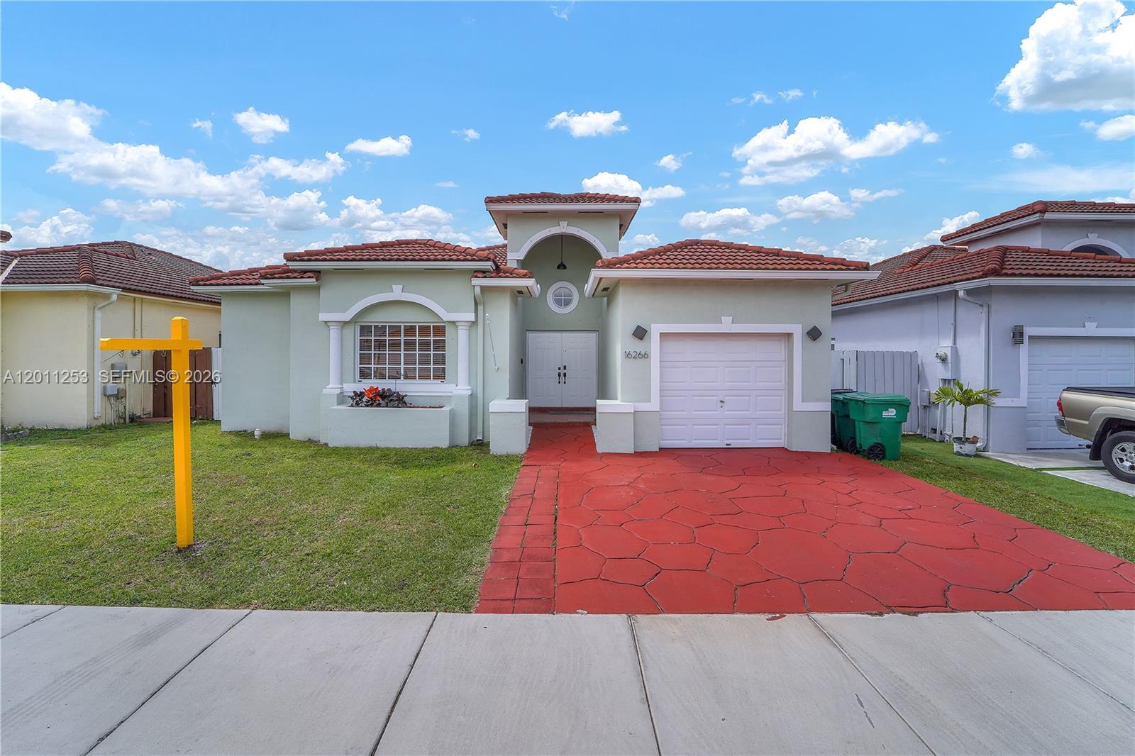 A single-story house with a red tile roof, light green stucco, and a red driveway — 16266 SW 54th Ter # 0, Miami FL 33185, MIAMI, FL