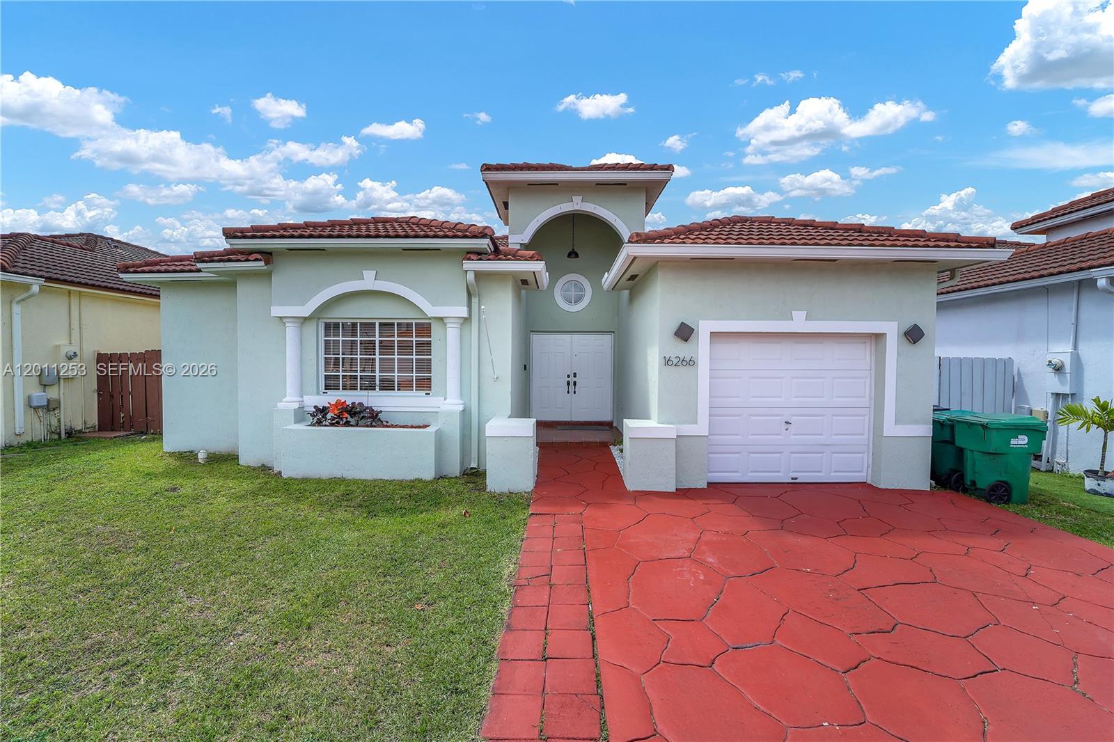 A single-story house features a red paved driveway, a garage, and a light green exterior — 16266 SW 54th Ter # 0, Miami FL 33185, MIAMI, FL