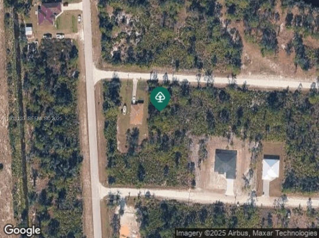 This is an aerial map view showing a residential lot with a house and surrounding vegetation — 27037 SEEGER DR, Punta Gorda FL 33955, PUNTA GORDA, FL