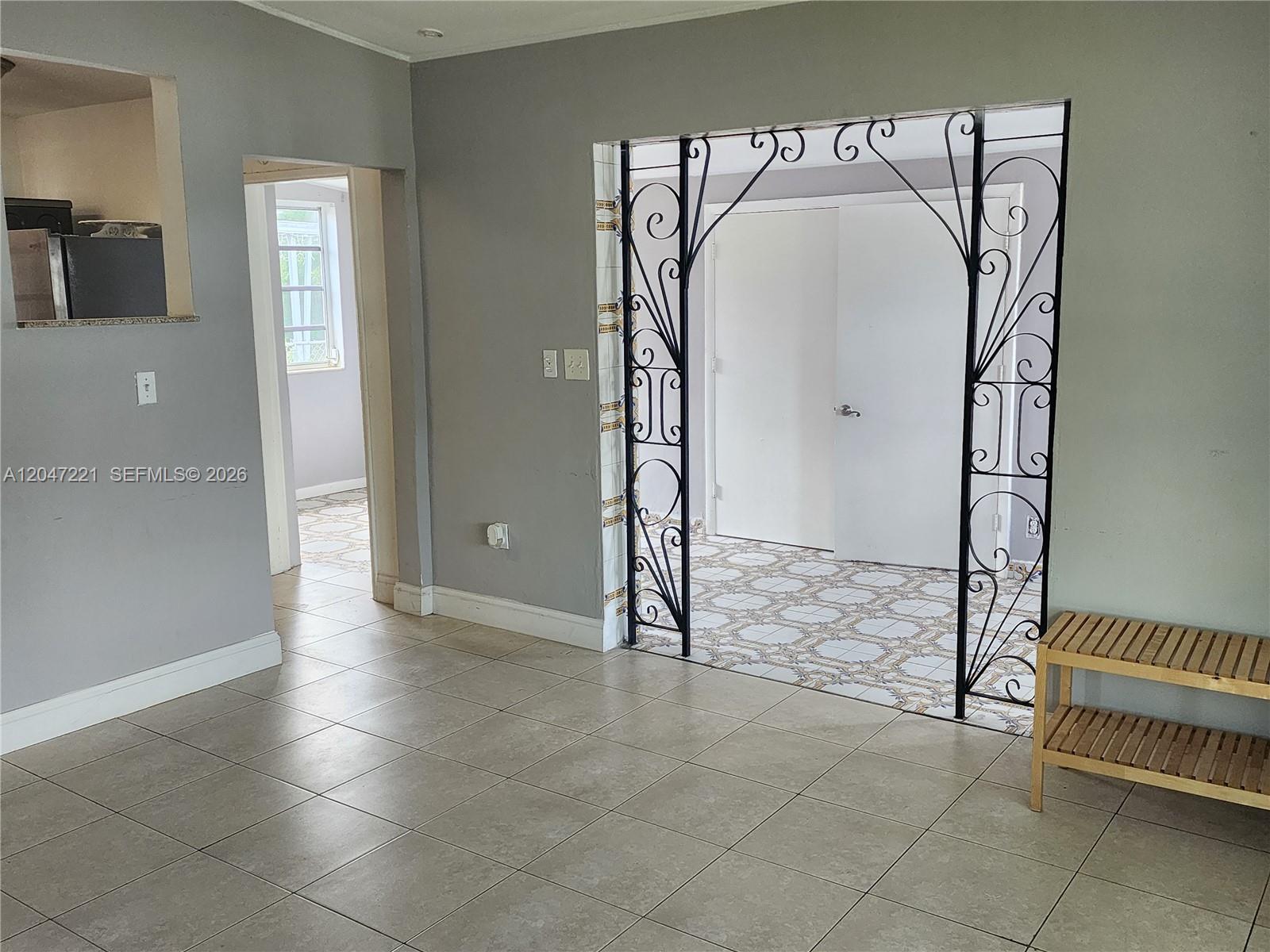 A room with gray walls, tiled floors, and a decorative black metal archway — 4100 SW 36th St # 0, West Park FL 33023, WEST PARK, FL