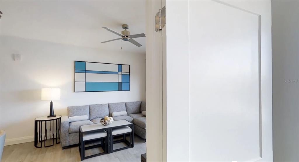 A living room features a grey sectional sofa, a coffee table, and a ceiling fan — 14501 GROVE RESORT AVENUE UNIT 2423, WINTER GARDEN, FL