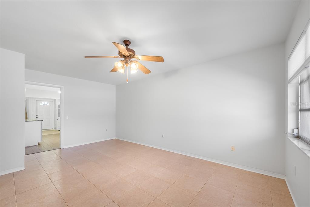 An empty room with light-colored walls, tile flooring, and a ceiling fan — 3775 59TH STREET N UNIT 2, ST PETERSBURG, FL