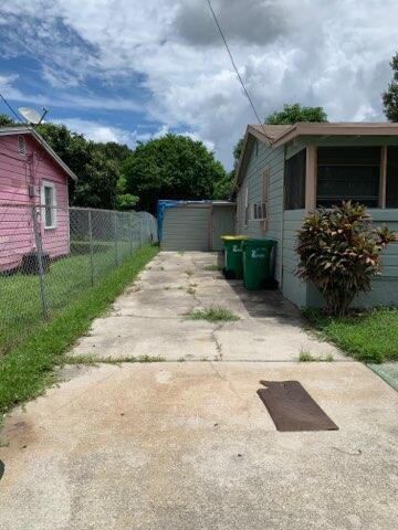 A concrete driveway runs between a pink house and a light blue house — 242 A Lane, Cocoa FL 32926, COCOA, FL