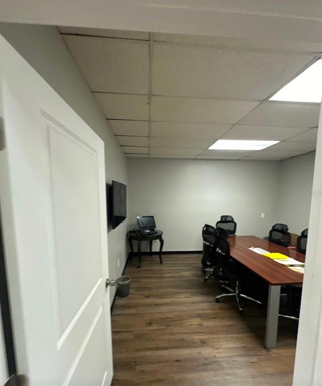 A conference room features a long wooden table, office chairs, and a drop ceiling — 9501 N NEBRASKA AVENUE, TAMPA, FL