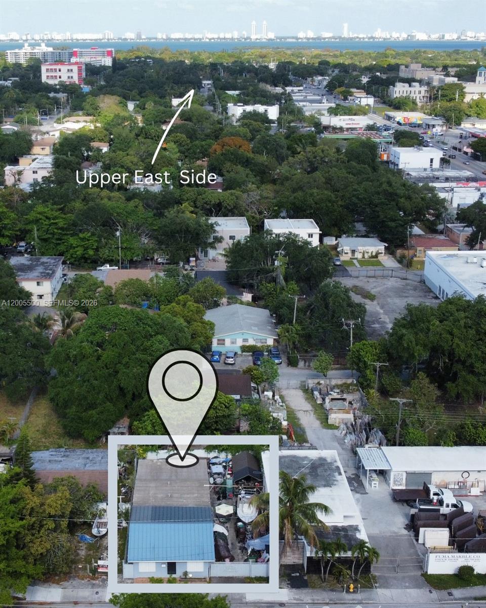 An aerial view shows a rectangular building with a blue roof and a fenced yard — 5501 NW 2nd Ave, Miami FL 33127, MIAMI, FL