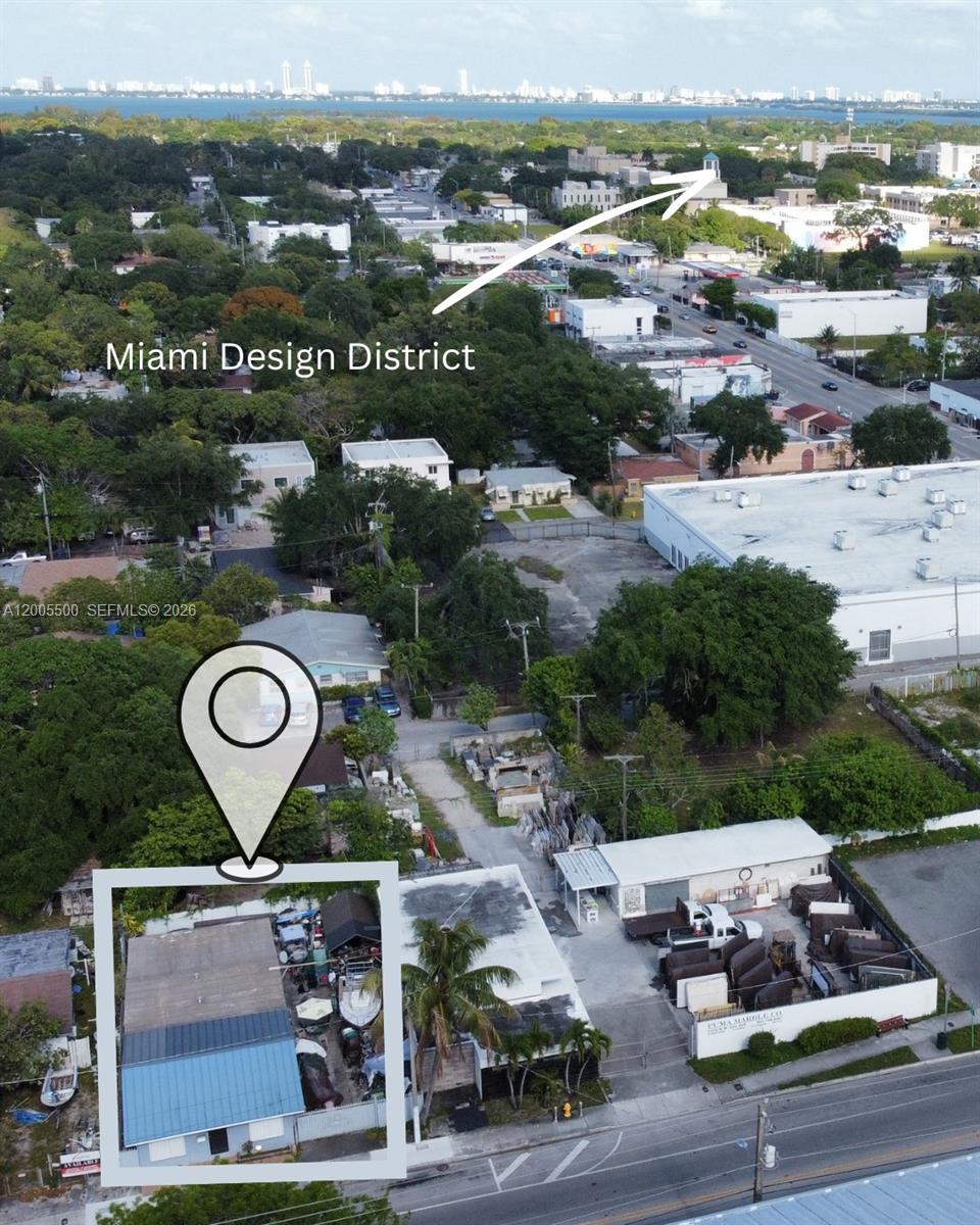 This aerial view shows a commercial property with a fenced lot and warehouse buildings — 5501 NW 2nd Ave, Miami FL 33127, MIAMI, FL