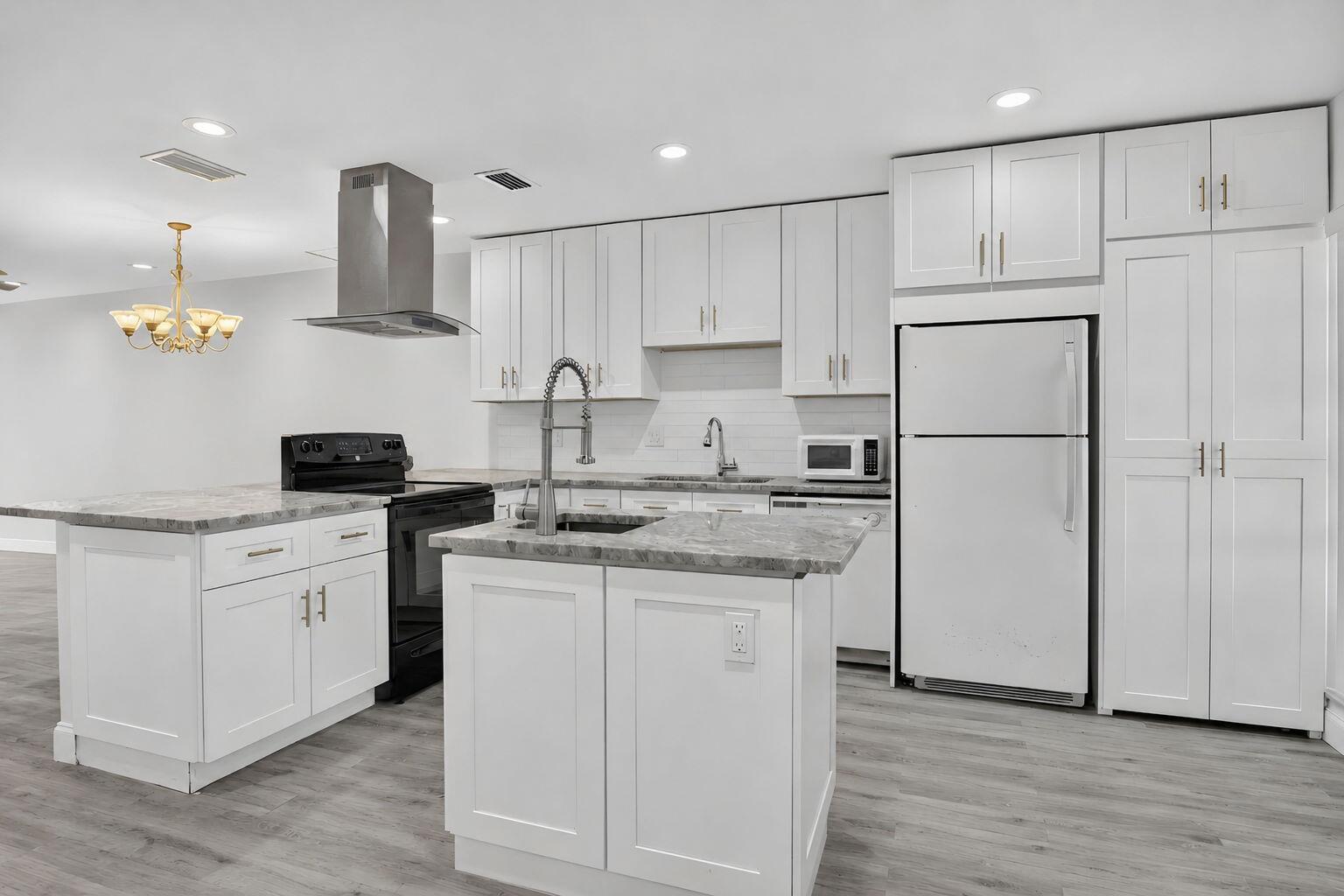 A modern kitchen features white cabinetry, a marble-patterned island, stainless steel appliances, and gray flooring — 20846 Vinesta Circle, Boca Raton FL 33433, BOCA RATON, FL