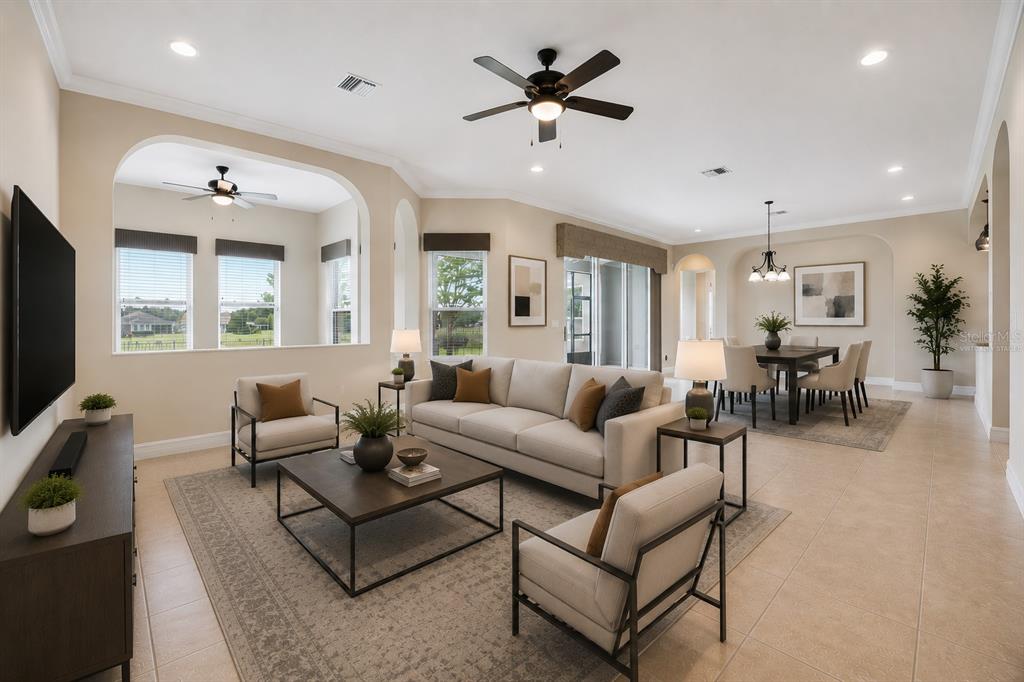 A living room with a beige sofa, two armchairs, a coffee table, and dining area — 228 BAYOU BEND ROAD, GROVELAND, FL