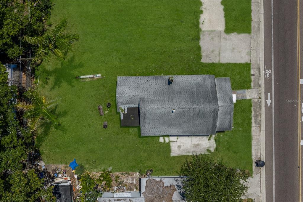 An aerial view shows a house with a gray roof situated on a grassy lot — 2001 15TH AVENUE S, ST PETERSBURG, FL