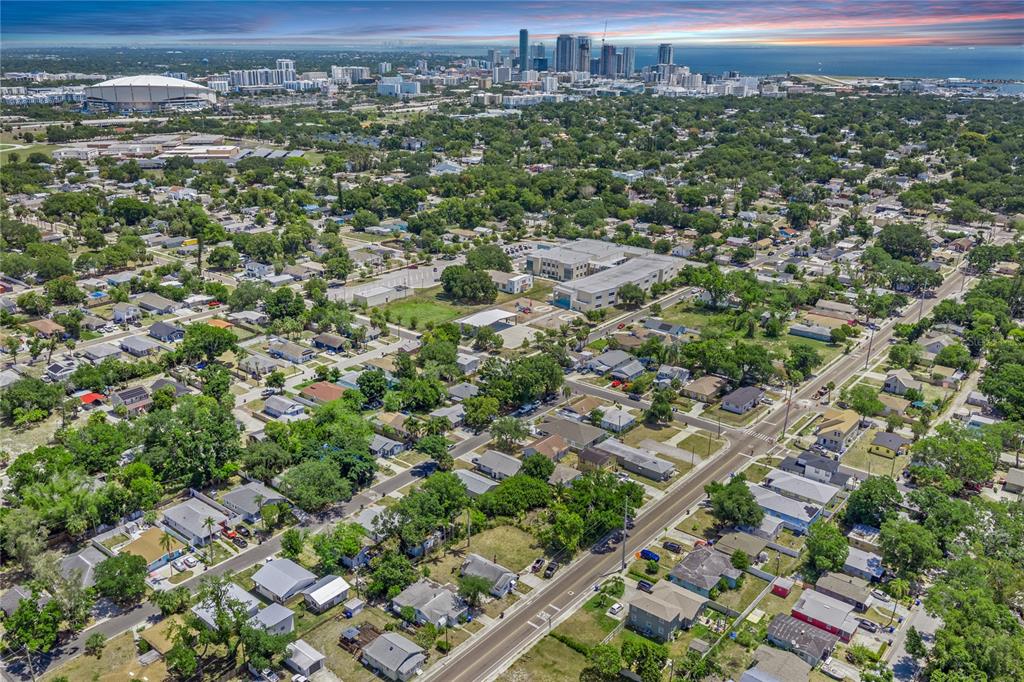 An aerial view of a residential neighborhood with a city skyline and stadium in the distance — 2001 15TH AVENUE S, ST PETERSBURG, FL