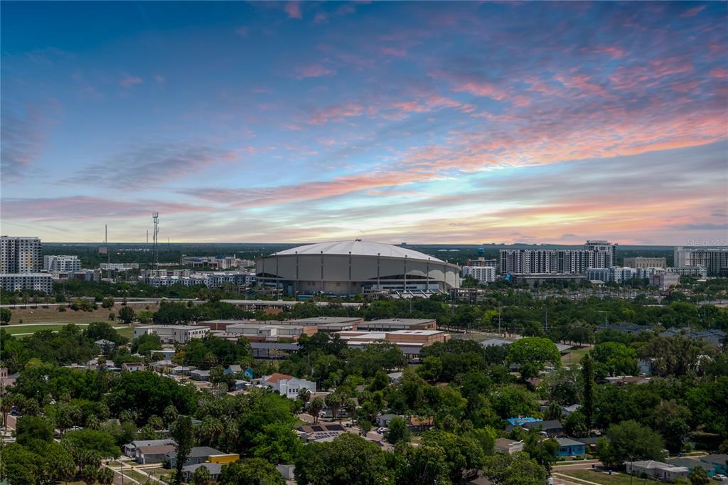 An aerial view shows a large domed stadium surrounded by city buildings and residential neighborhoods — 2001 15TH AVENUE S, ST PETERSBURG, FL